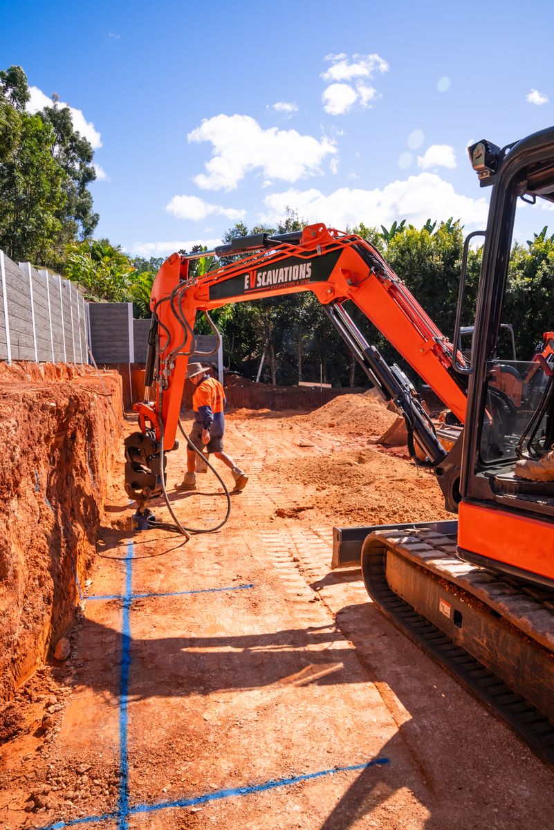 Excavator with auger attachment