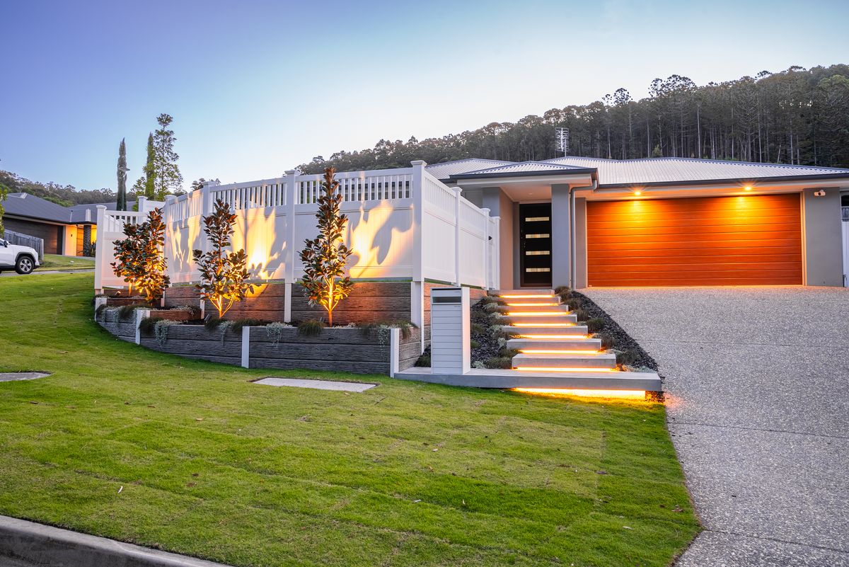 Finished white fence with landscaped terraces