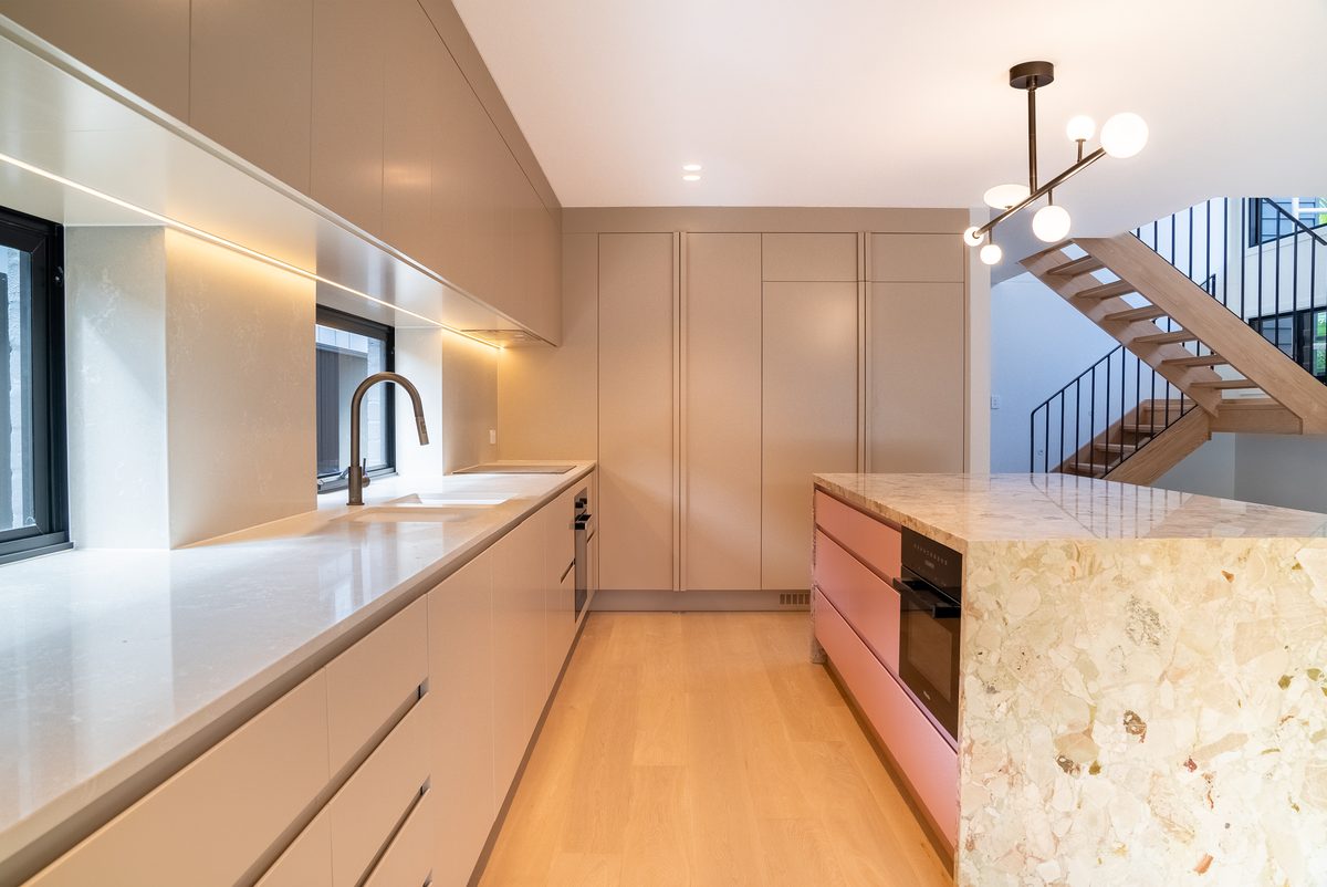 Blush galley kitchen beside the staircase