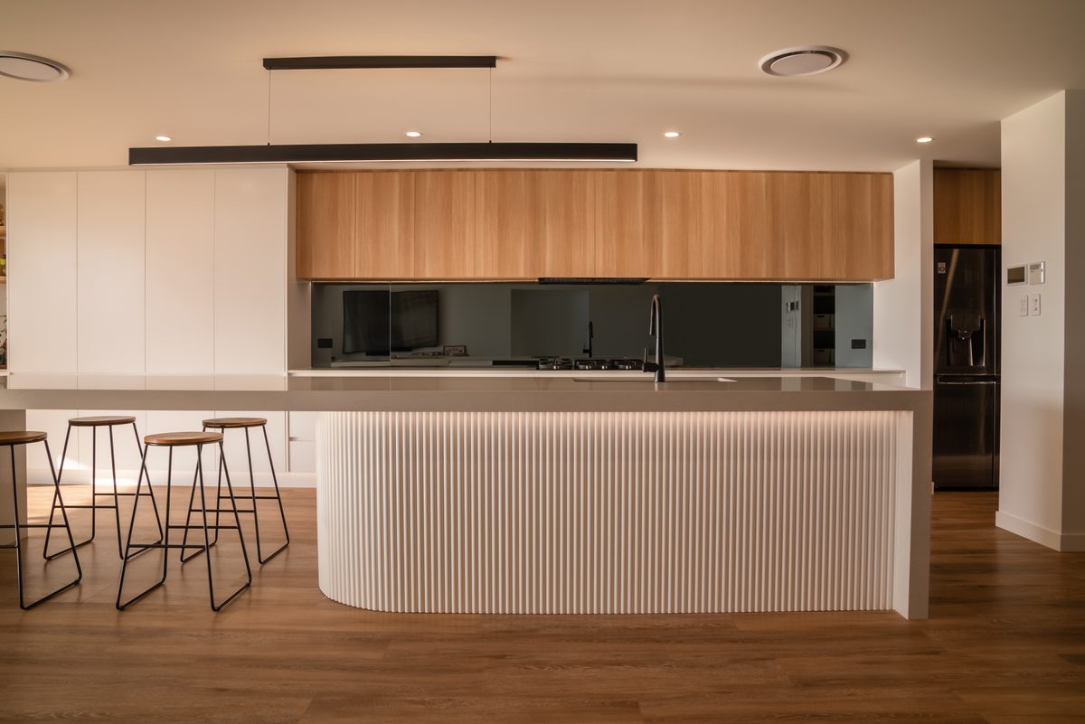 Fluted island and oak overhead cabinetry