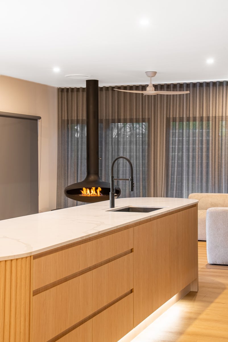 Oak island bench with suspended fireplace