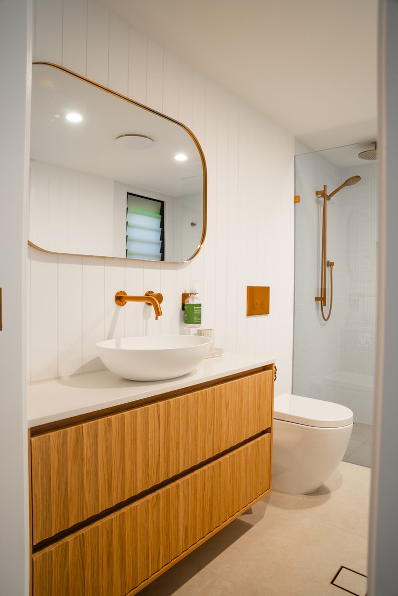 Timber vanity with brushed brass tapware