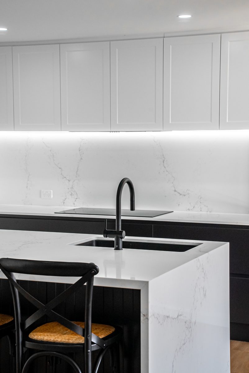 Shaker kitchen sink and stone splashback