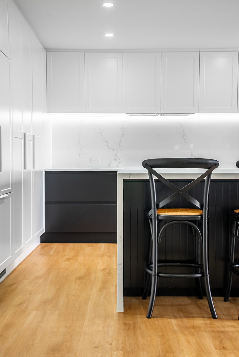 White shaker kitchen with black island
