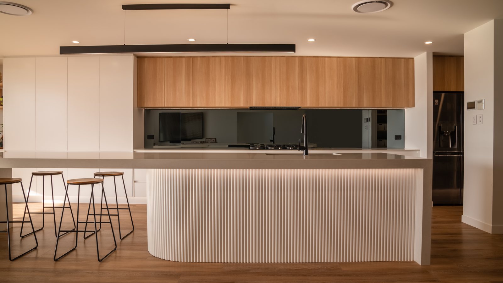 Fluted island kitchen built by Nalu Cabinets