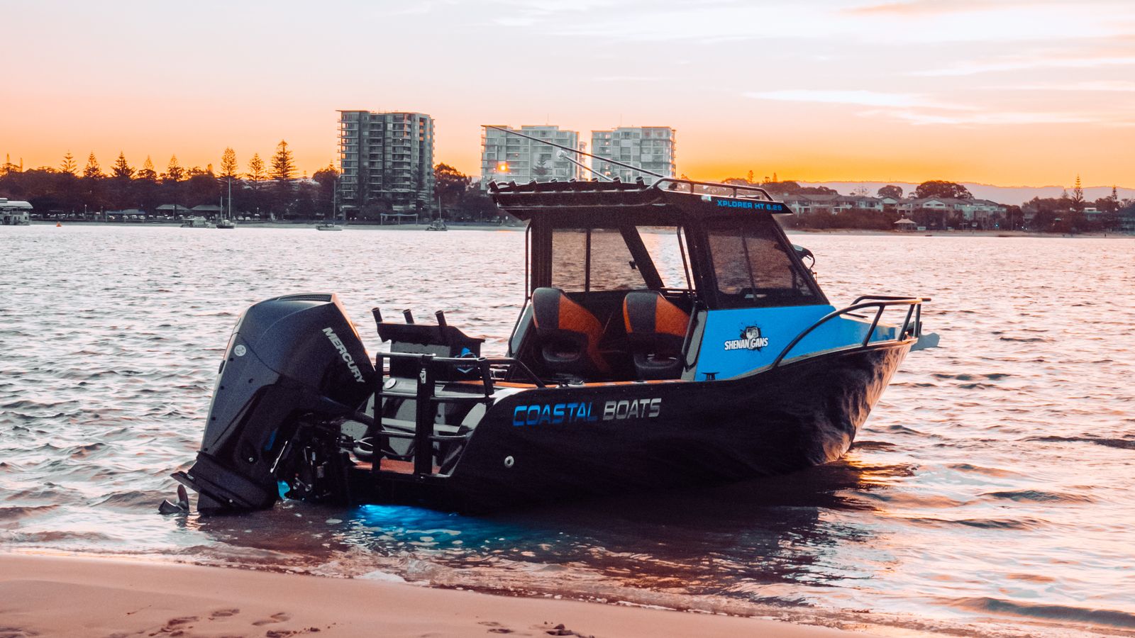 Coastal Boats plate boat on the sand at sunset