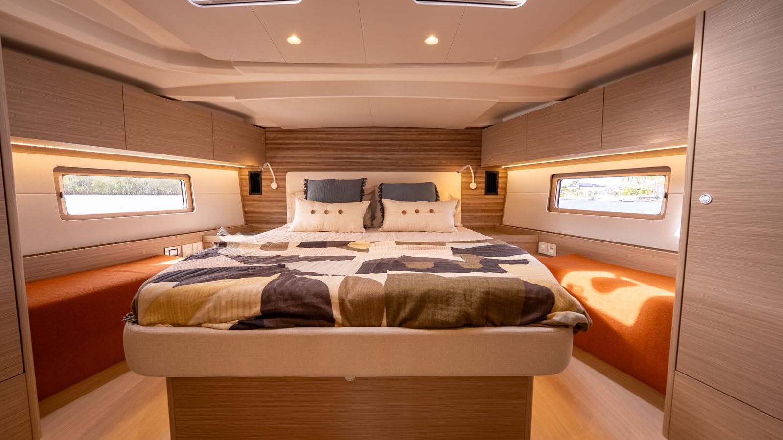 Owners cabin aboard a yacht with timber joinery and island berth