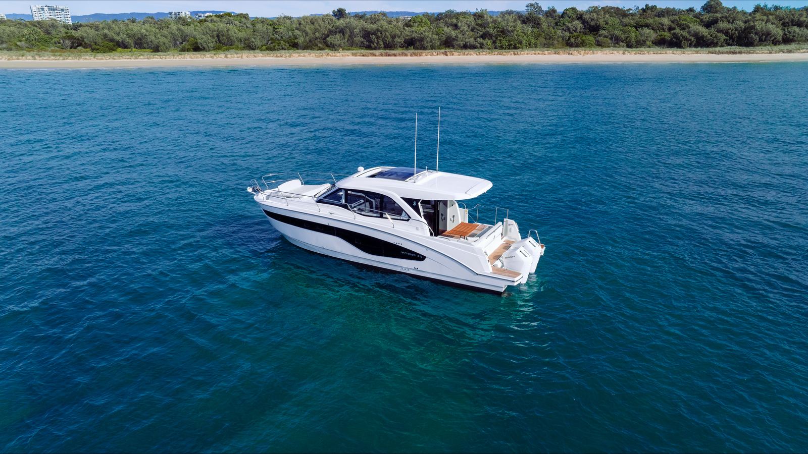 Motor yacht at anchor off the beach shot from the air